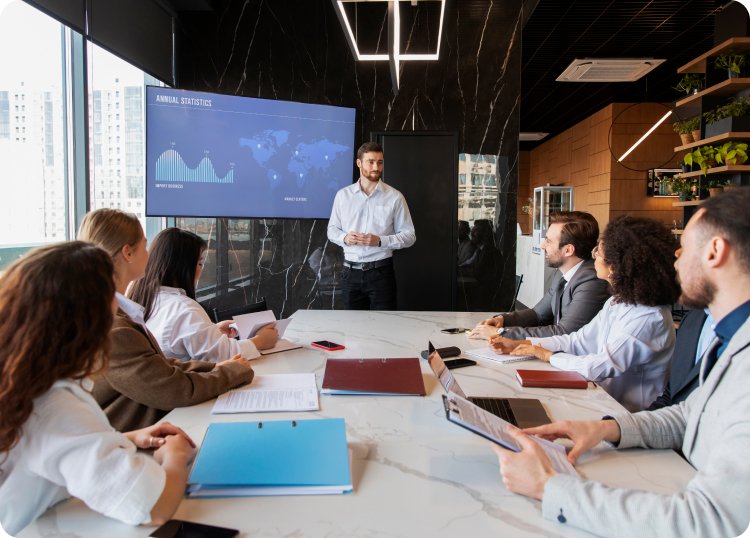 Business professional presenting financial data to a group, symbolizing team collaboration and data-driven decisions