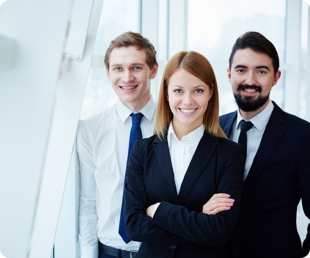 Smiling group of business professionals standing together, symbolizing teamwork and collaboration