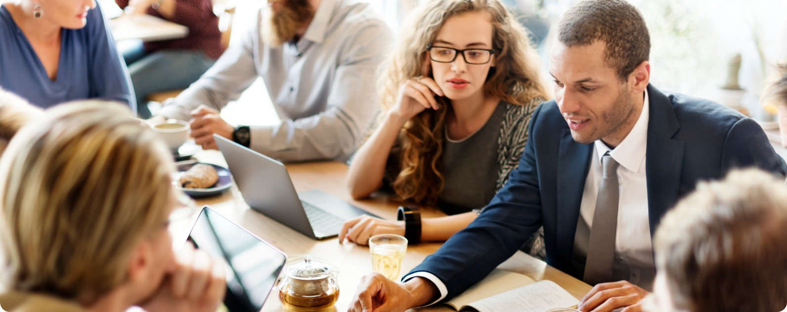 Professional woman working at a desk with a laptop and documents